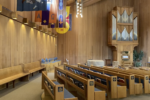 Photo of the interior of St. John's sanctuary. The organ and pews are visible on the left side of the sanctuary.