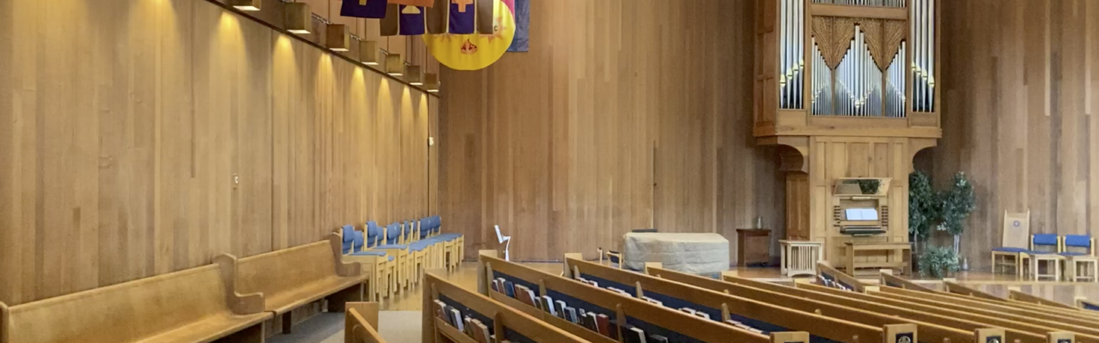 Photo of the interior of St. John's sanctuary. The organ and pews are visible on the left side of the sanctuary.